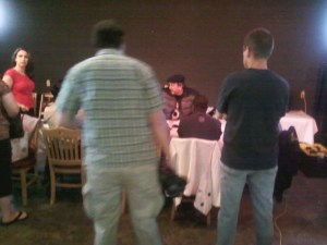 Director/writer Fred Terling gathers the main actors and crew to ready them for the scene before extras are added.