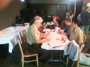 A couple officers or actors going through lines.